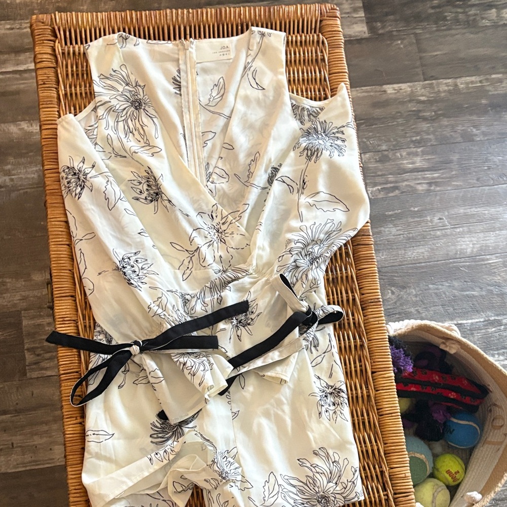 J.O.A. Los Angeles Floral Romper with Black Tie at wrist.